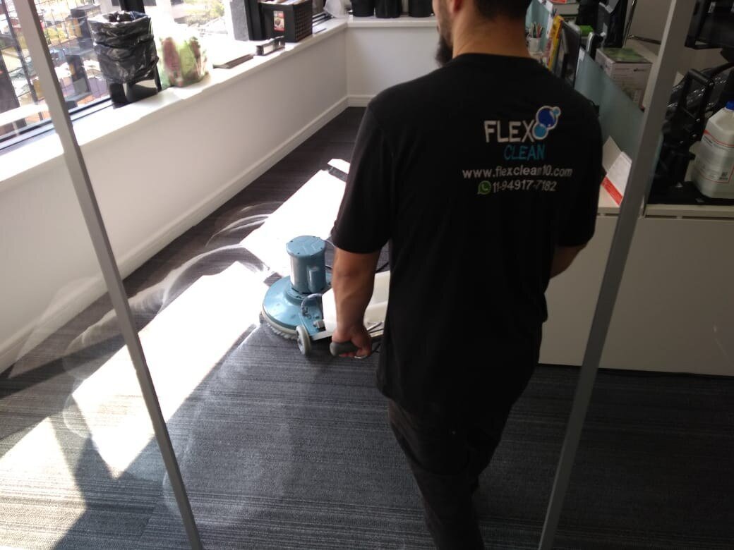 Técnico da Flex Clean lavando o carpete de um escritório com máquina rotativa
